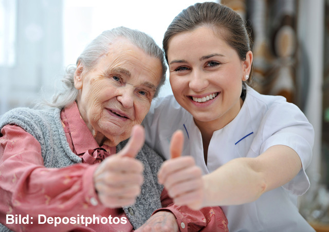 Senior woman and female nurse are showing thumbs up